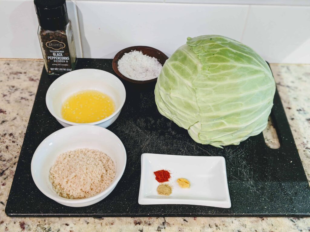 cabbage, panko, melted butter, salt, and spices on a cutting board