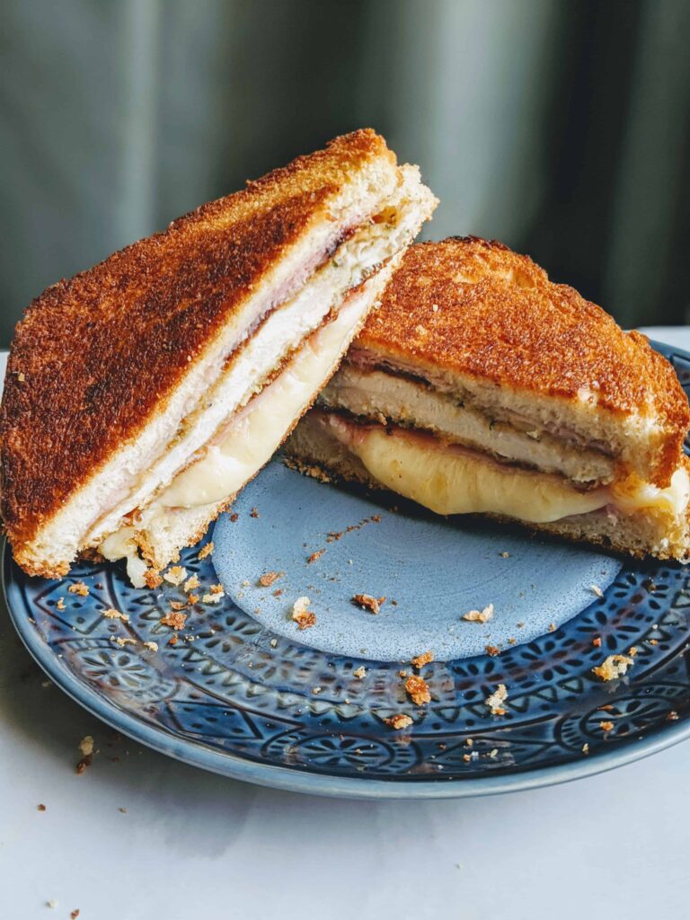 chicken cordon blue sandwich on a blue plate