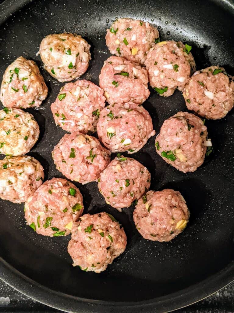 raw glazed chicken meatballs in a pan
