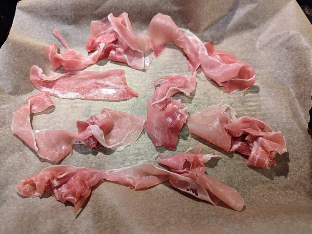 torn prosciutto on a tray